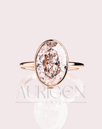 Modern Oval Cut Moissanite and Lab Grown Diamond Bezel Solitaire Ring in 14K Rose Gold